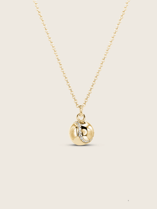 Gold plated tennis ball pendant necklace with semi pavé CZ stones on a fine chain