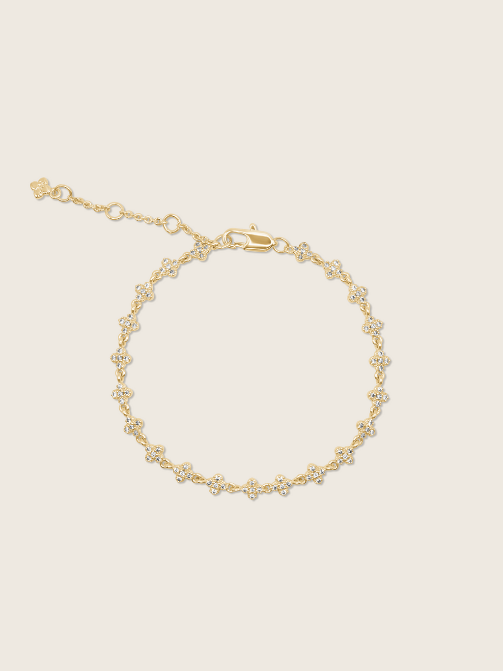 Gold plated pavé bracelet displayed flatly on a white background, highlighting the sparkling detail of the chain bracelet.