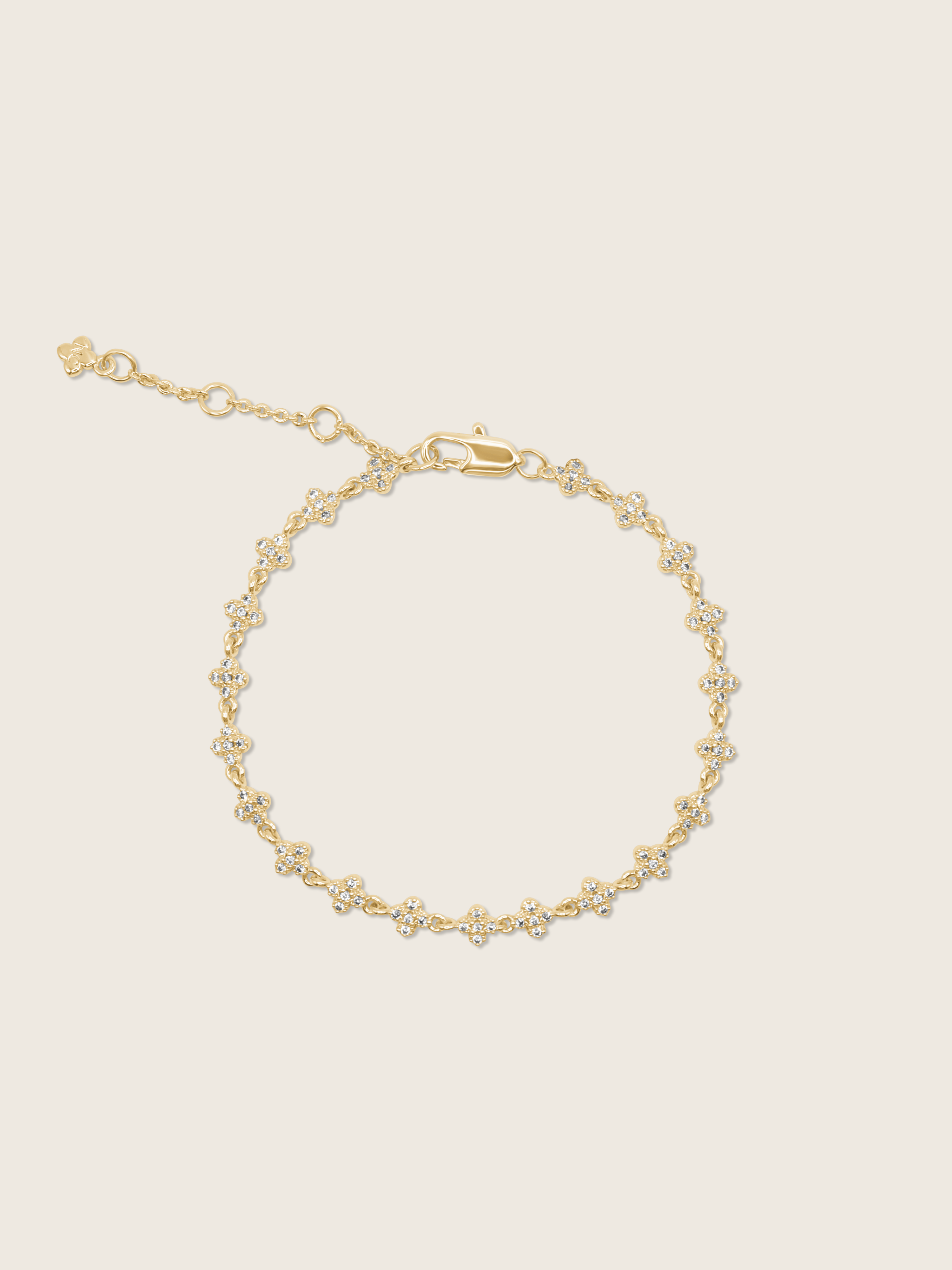 Gold plated pavé bracelet displayed flatly on a white background, highlighting the sparkling detail of the chain bracelet.