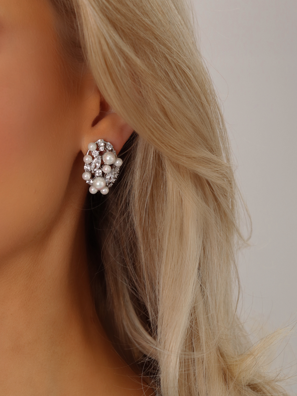 Model wearing Grace earrings featuring freshwater pearls and sparkling CZ stones with premium white gold plating