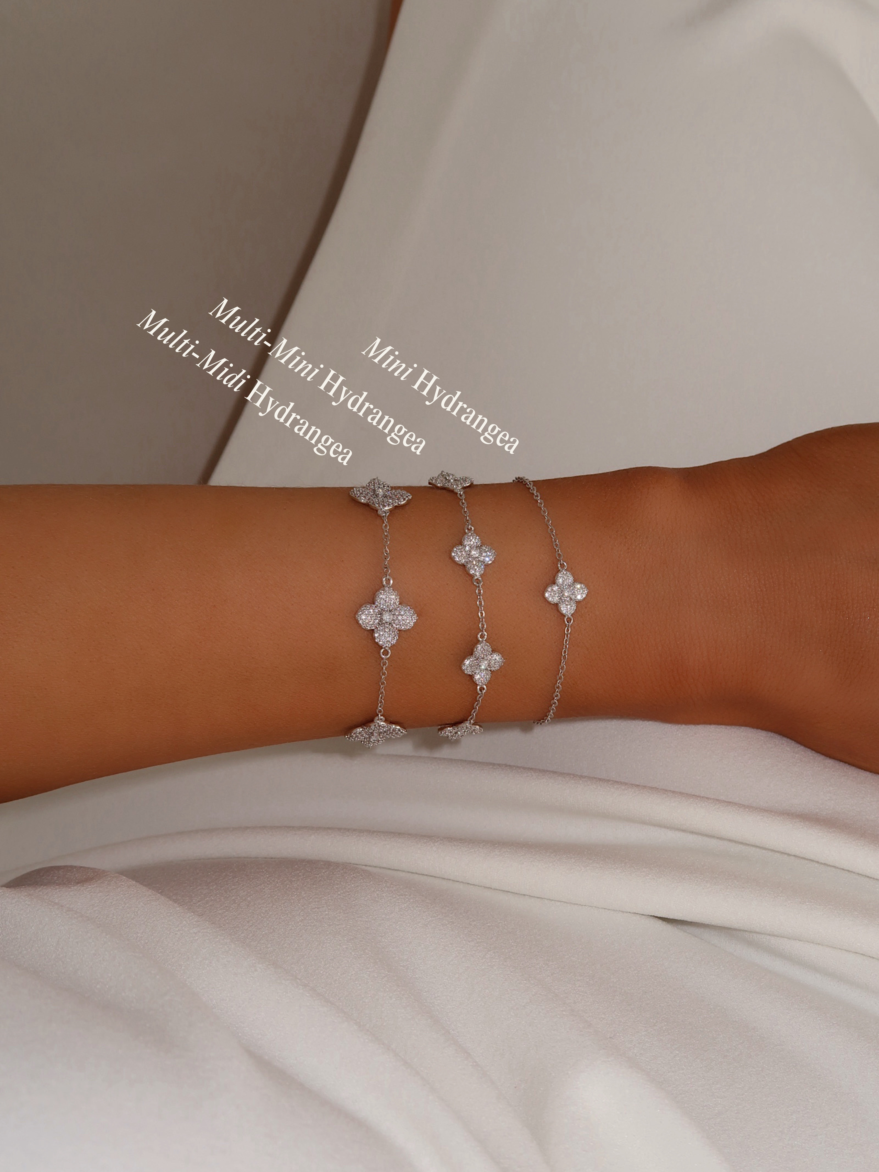 White Gold Hydrangea bracelet stack showing multi-mini, mini and multi-midi styles on wrist