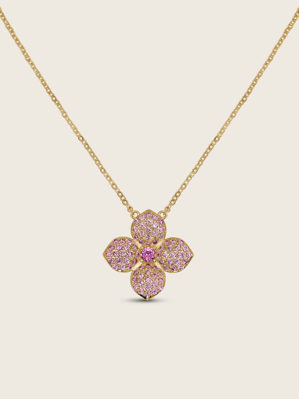 Gold-plated hydrangea pendant necklace with light pink cubic zirconia stones and central embellishment, displayed on white background