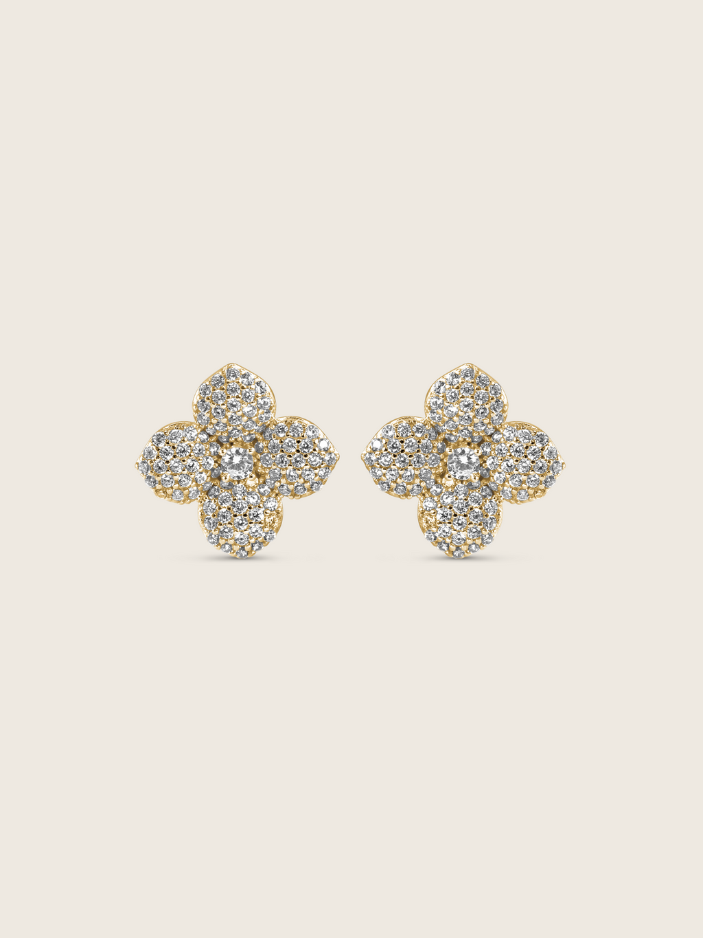 Gold plated flower stud earrings with pavé clear stones in a four-petal hydrangea design, shown on a neutral background