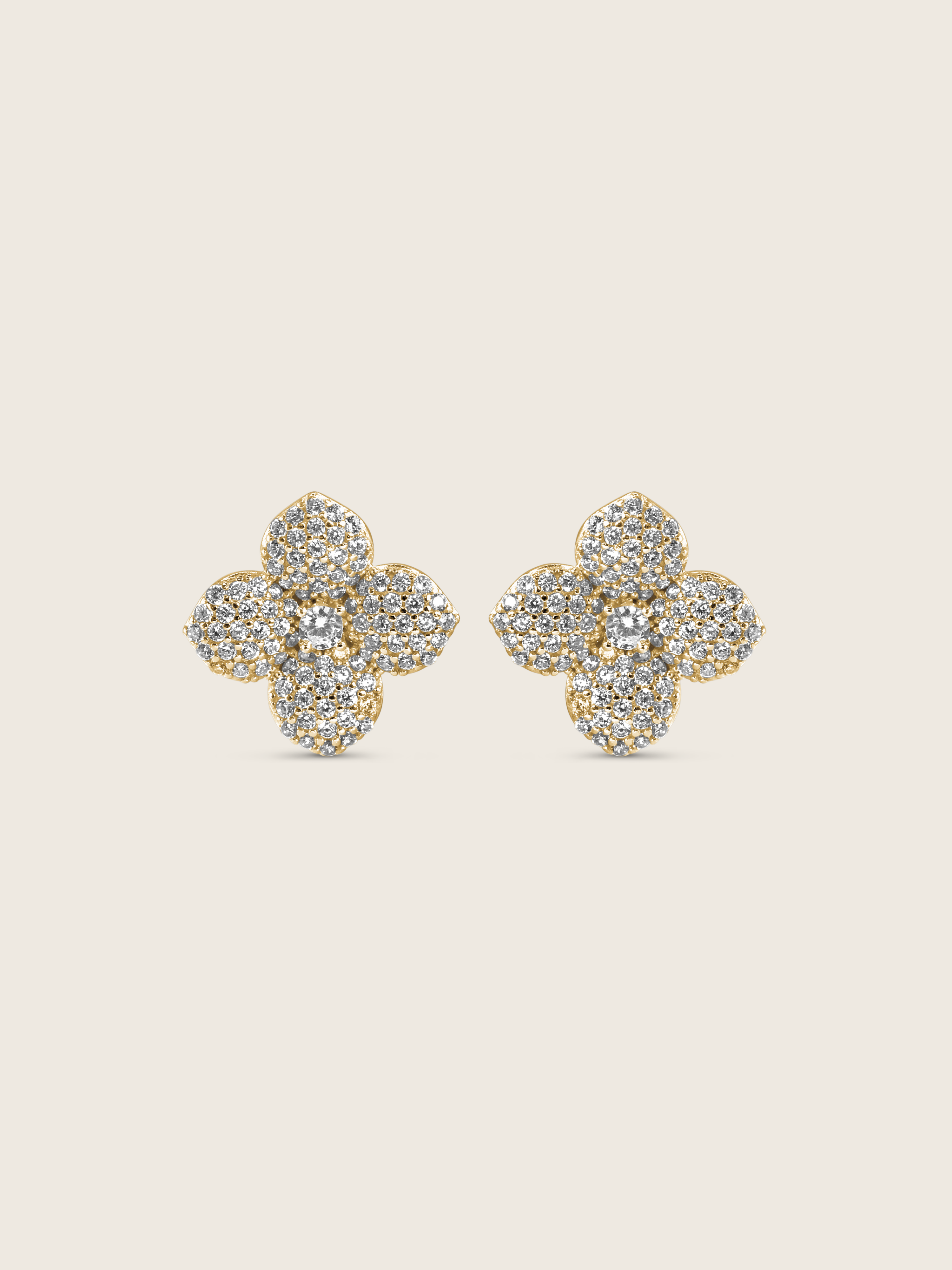 Gold plated flower stud earrings with pavé clear stones in a four-petal hydrangea design, shown on a neutral background