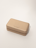 Large champagne jewellery case closed with embossed Nice Cream London logo and gold zip.