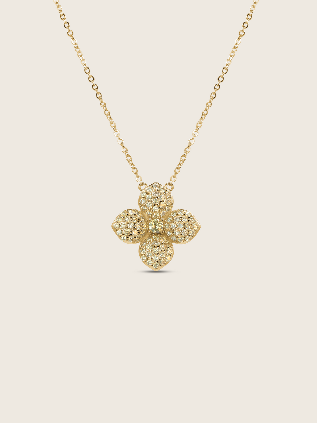 Gold plated Lemon Drop necklace with a pavé crystal four-petal flower pendant on a fine chain, shown on a neutral background.