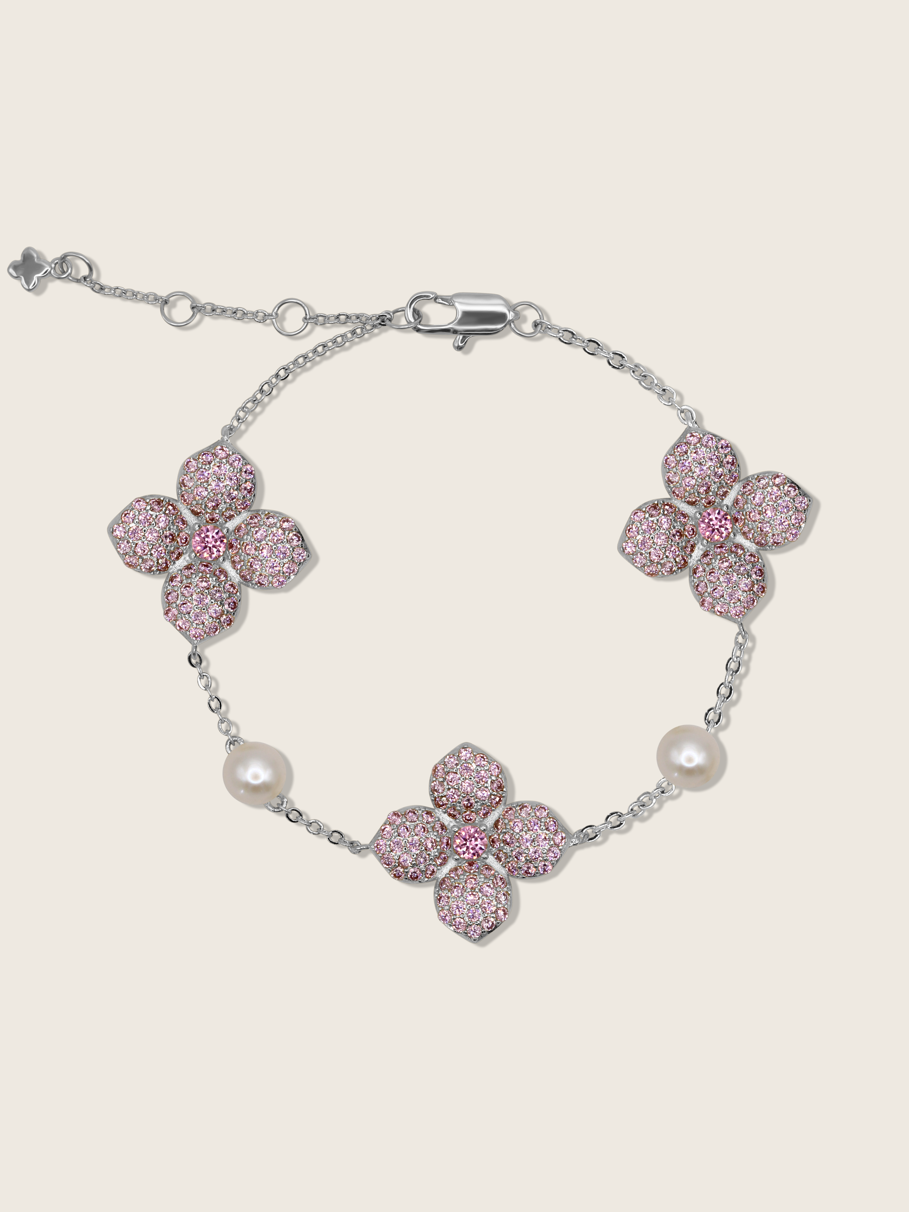 White Gold-plated hydrangea bracelet with pavé-set light pink stones and freshwater pearls, displayed on white background