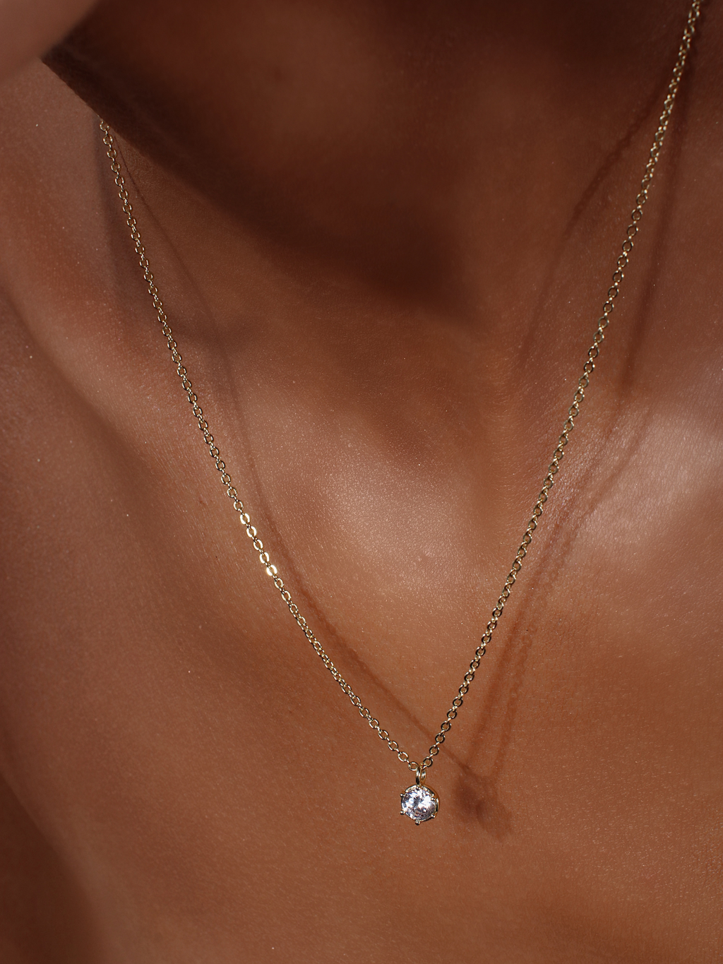 Close-up of Luna gold necklace featuring solitaire cubic zirconia pendant on fine gold plated chain