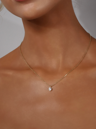 Model wearing Luna gold pendant necklace with cubic zirconia stone, 14k gold plated brass