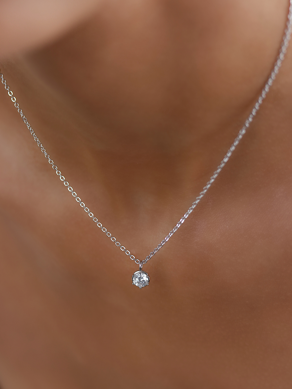 Close up of Luna necklace in white gold plating featuring solitaire cubic zirconia pendant