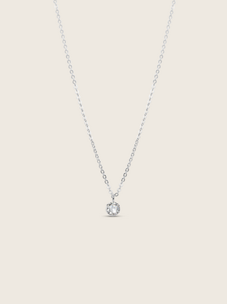 Luna necklace with premium white gold plating and solitaire cubic zirconia pendant, flat lay on white background