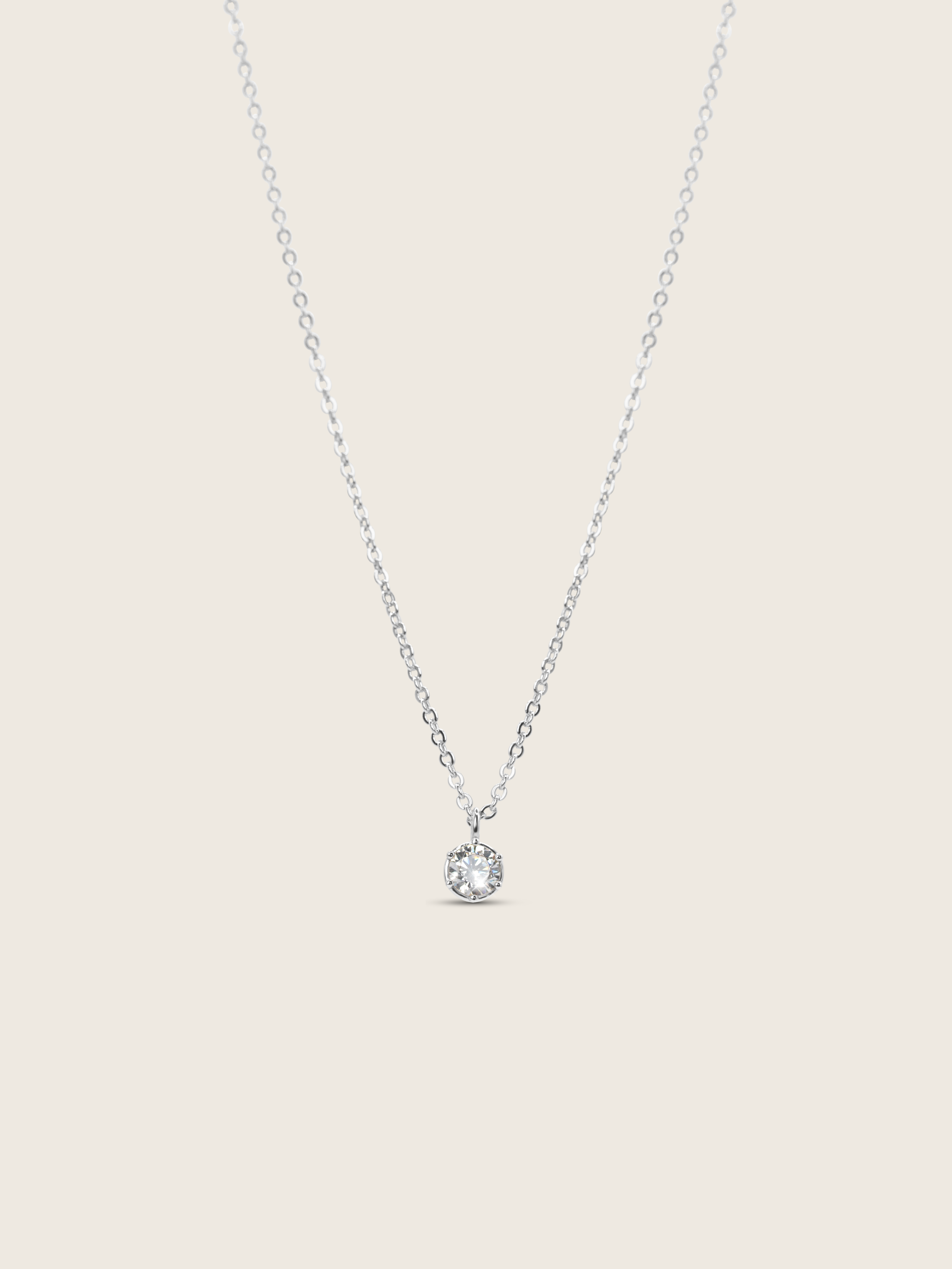 Luna necklace with premium white gold plating and solitaire cubic zirconia pendant, flat lay on white background