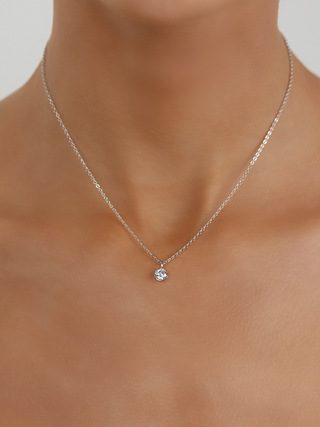 Luna necklace in premium white gold plating with solitaire cubic zirconia pendant, worn on neckline
