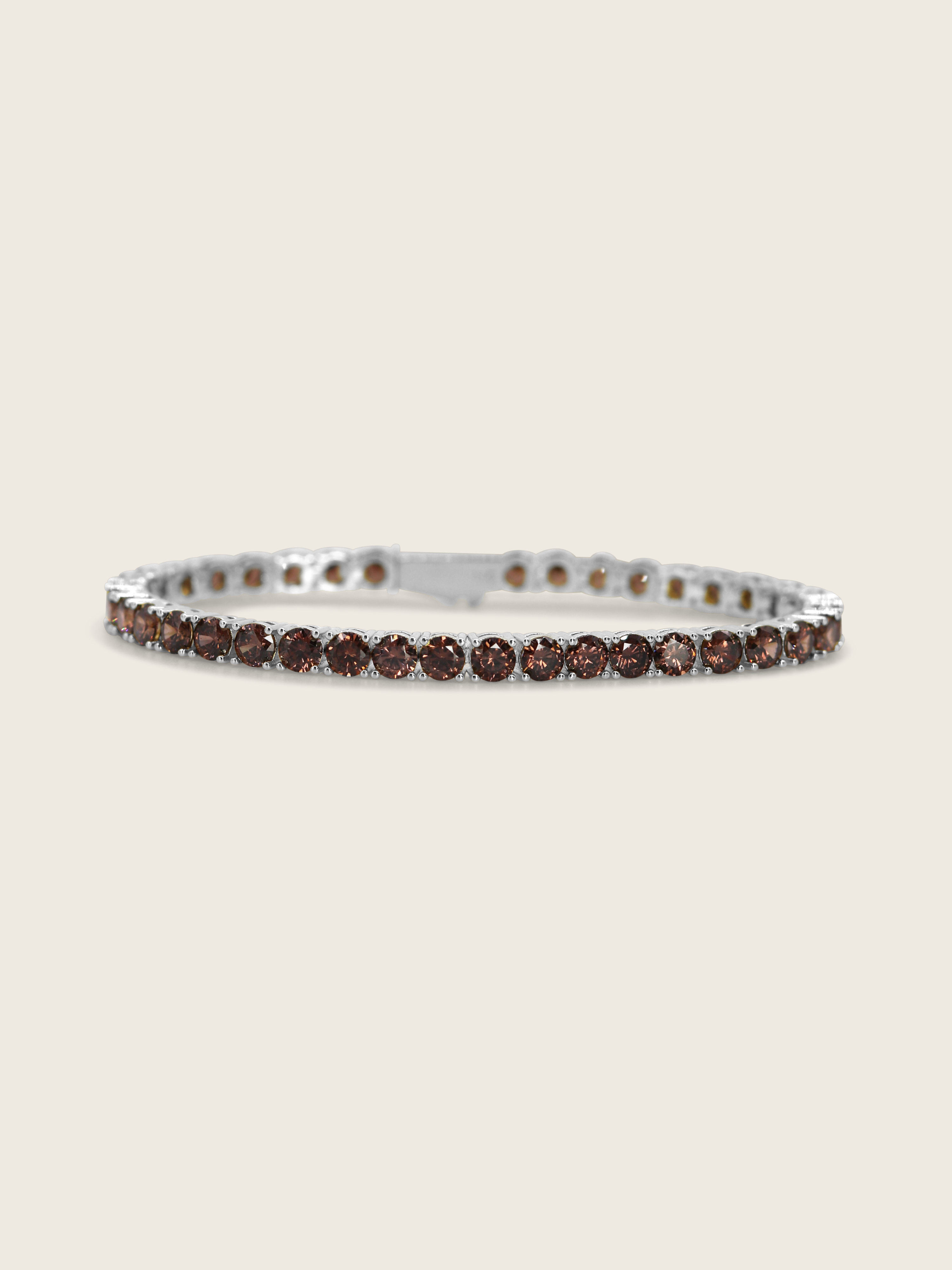 Maria tennis bracelet in premium white gold with wine coloured cubic zirconia stones on neutral background