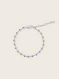 White gold plated micro hydrangea bracelet with adjustable chain displayed flat on white background