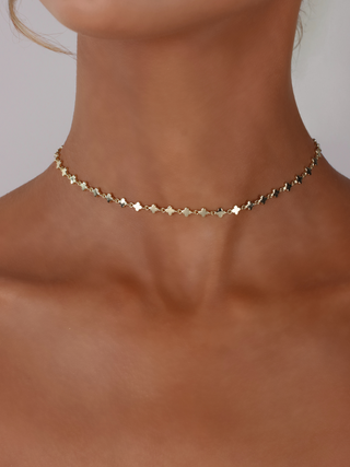 Model wearing Micro Hydrangea Necklace in 14k gold plated brass with delicate flower chain design, dainty choker style jewellery