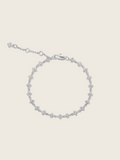 Micro hydrangea pavé bracelet in white gold displayed flatly on a white background, highlighting the sparkly, detailed design of the chain bracelet.