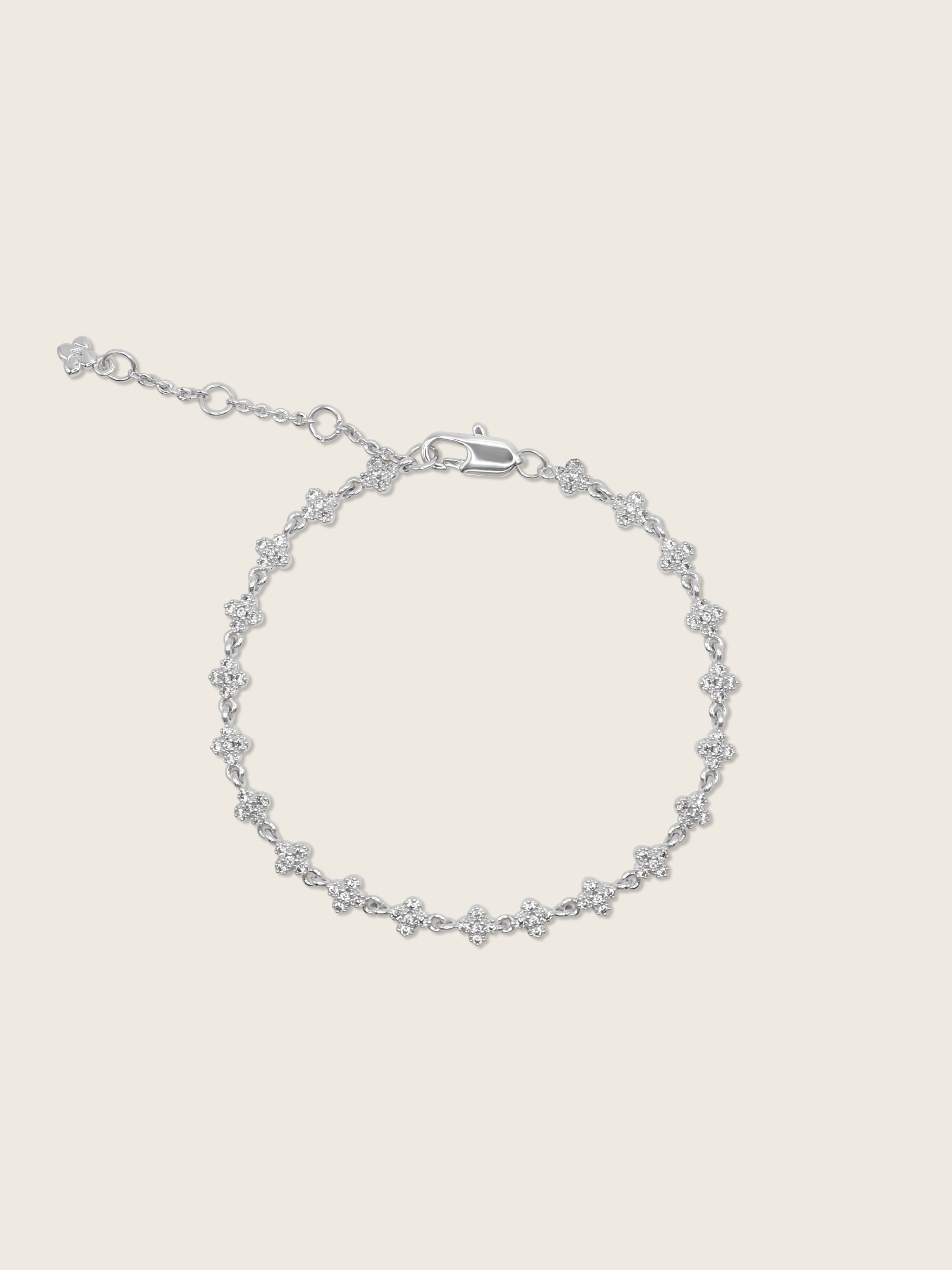 Micro hydrangea pavé bracelet in white gold displayed flatly on a white background, highlighting the sparkly, detailed design of the chain bracelet.