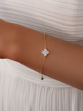 Close-up of the Mini Crystal Hydrangea Bracelet on a model’s wrist, paired with a white dress, highlighting the delicate sparkle of the crystal hydrangea stones.