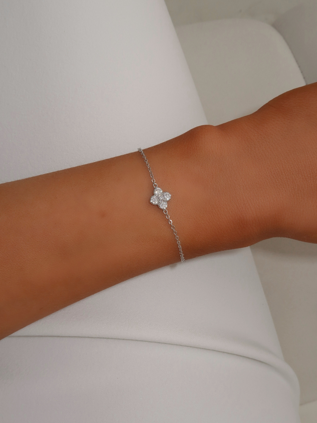 Close-up of mini hydrangea bracelet in premium White Gold plating worn on wrist