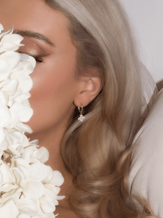 Model wearing Mini Hydrangea hoop earrings in gold plating with sparkly cubic zirconia, styled with white hydrangea flowers, soft glam aesthetic jewellery shoot