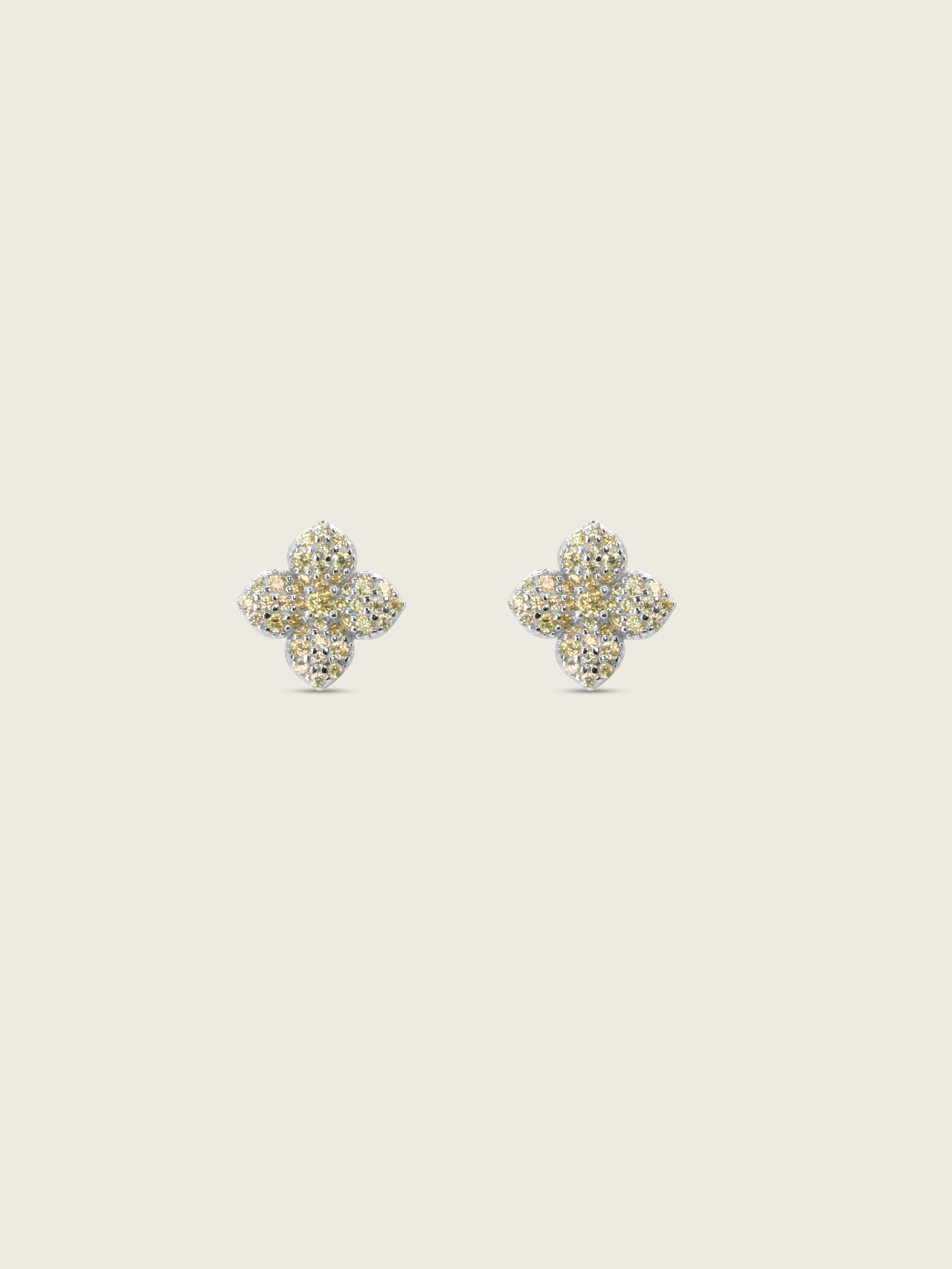 Mini hydrangea stud earrings in premium white gold with lemon yellow cubic zirconia on neutral background