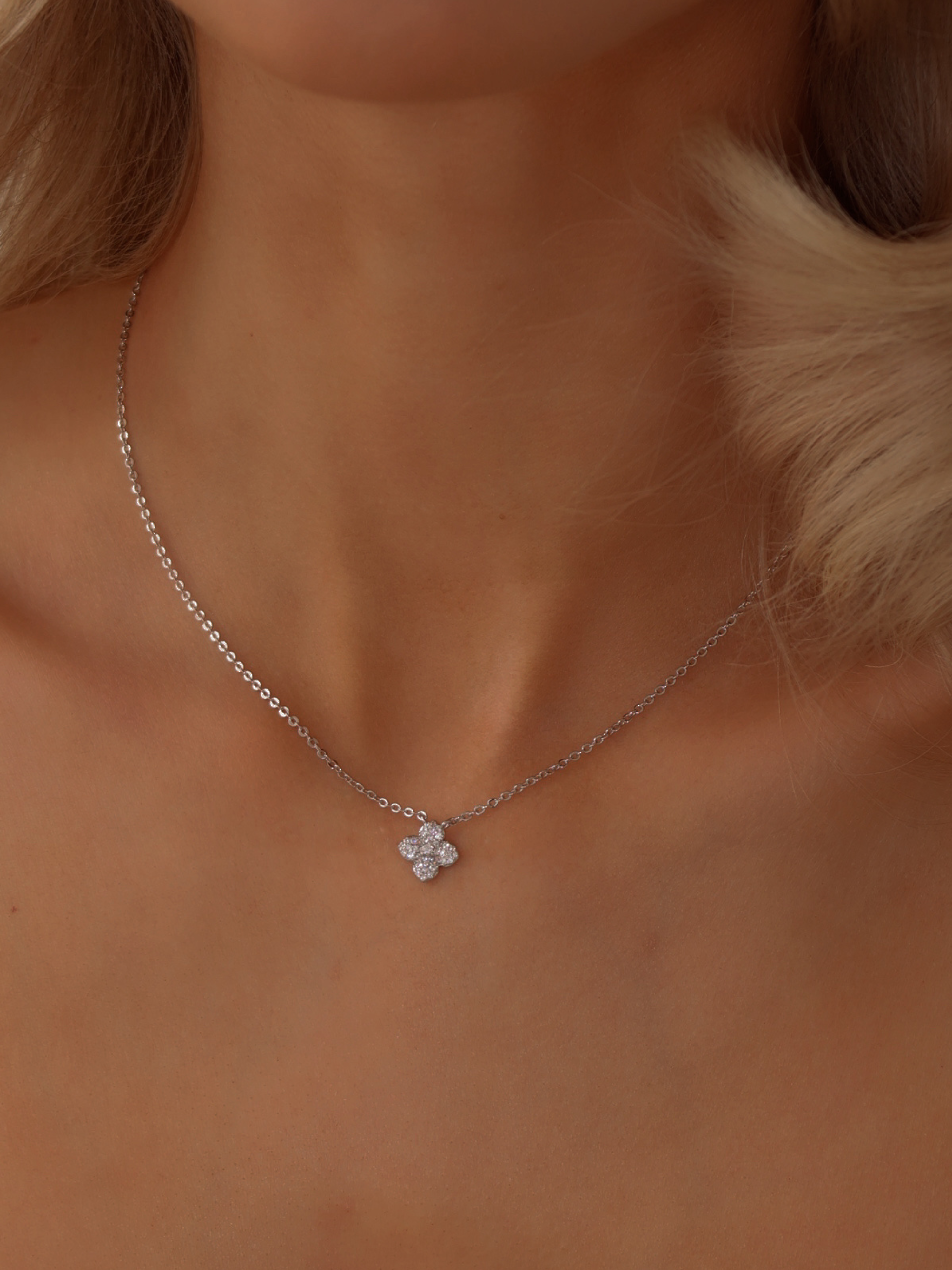 Mini Hydrangea necklace in premium White Gold plating worn on model, featuring a delicate pavé flower pendant on a fine chain