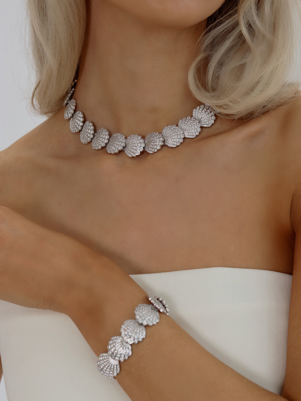 Muriel pavé bracelet and matching shell link necklace in White Gold with CZ stones, styled together on model