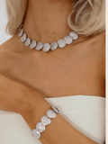 Model wearing Muriel pavé necklace and matching bracelet in White Gold with CZ stones and shell shaped design