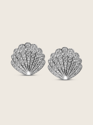 Muriel shell-shaped stud earrings in sterling silver with white gold plating and pavé-set cubic zirconia, vintage-inspired statement jewellery shown on a white background.