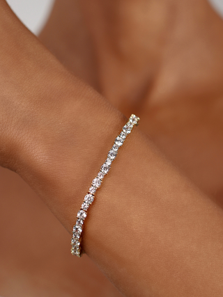 Nova tennis bracelet 14k gold plated brass with cubic zirconia stones styled on wrist close up