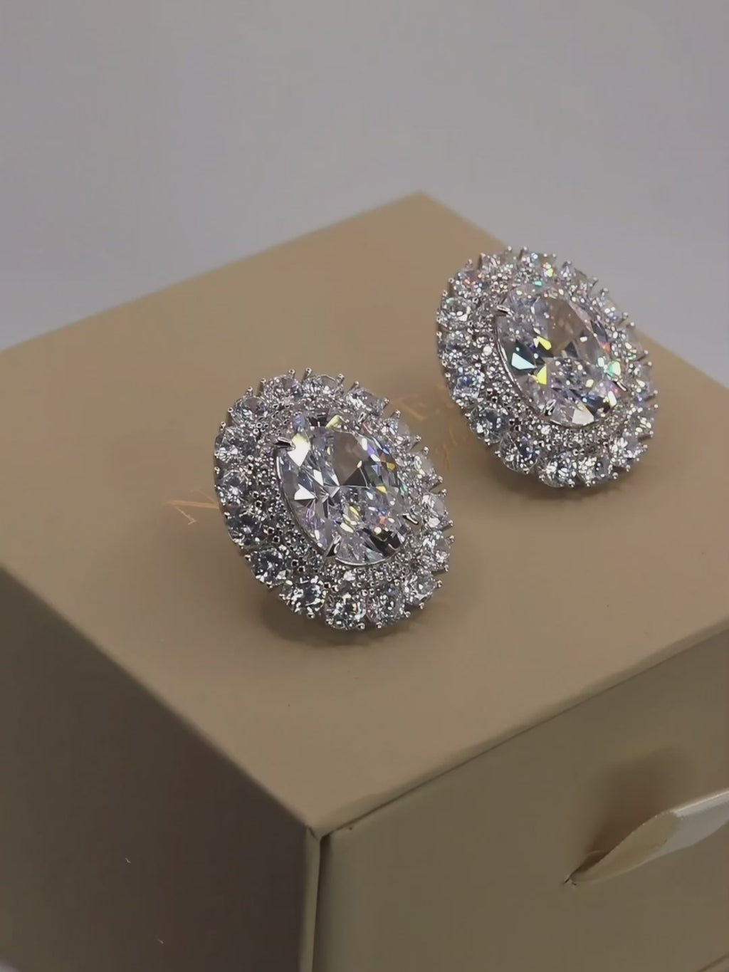 Video showcasing the Diana earrings with sparkling clear crystal CZ stones and premium White Gold plating on product packaging