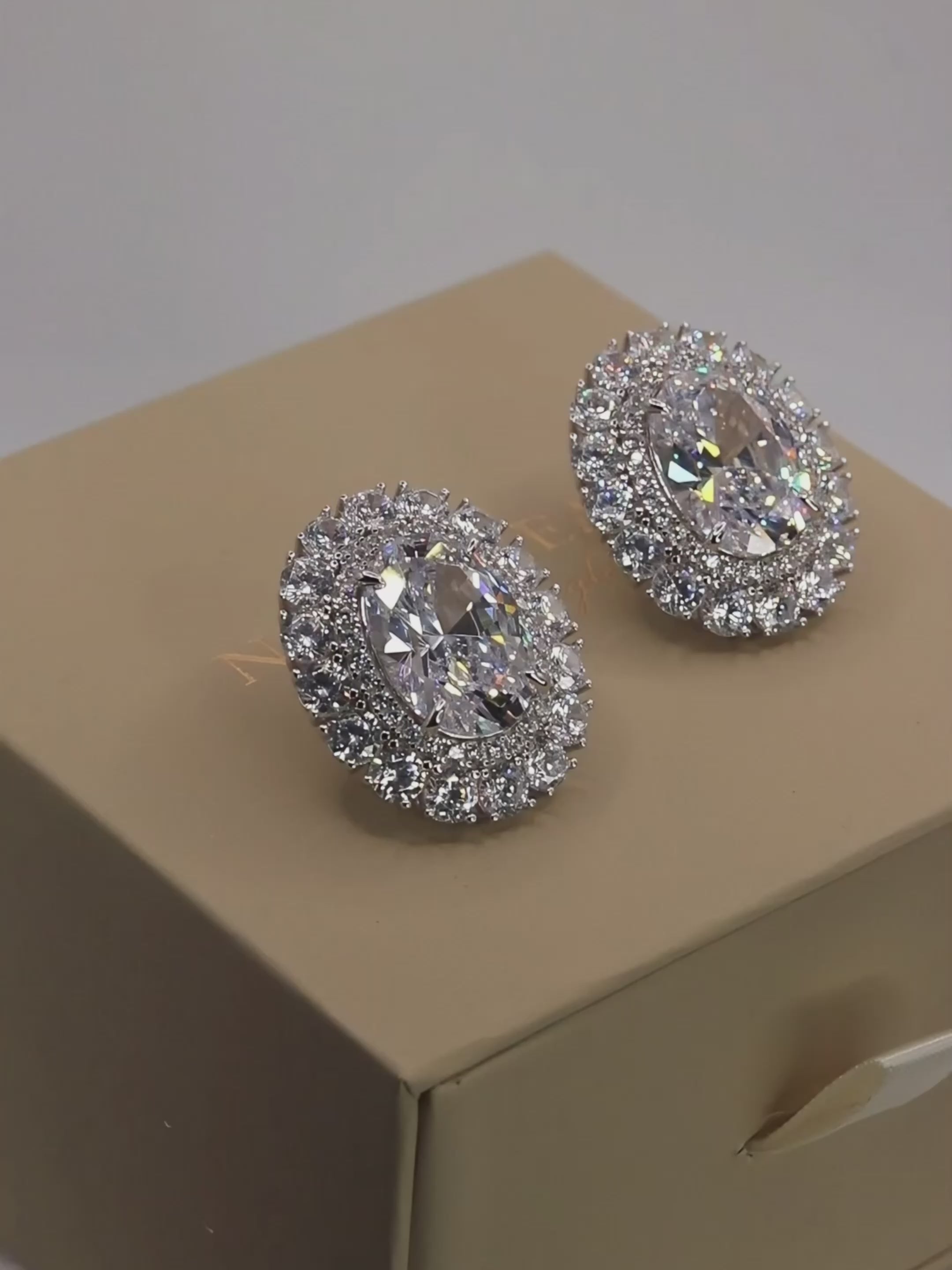 Video showcasing the Diana earrings with sparkling clear crystal CZ stones and premium White Gold plating on product packaging