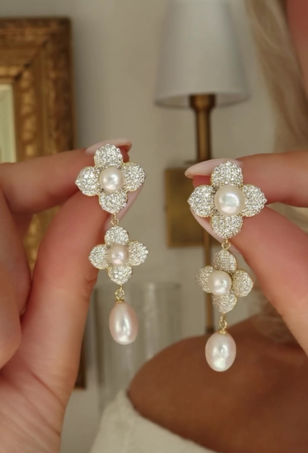 Gold Hydrangea Triple Pearl Earrings with freshwater pearls and CZ stones shown in motion to capture sparkle and movement