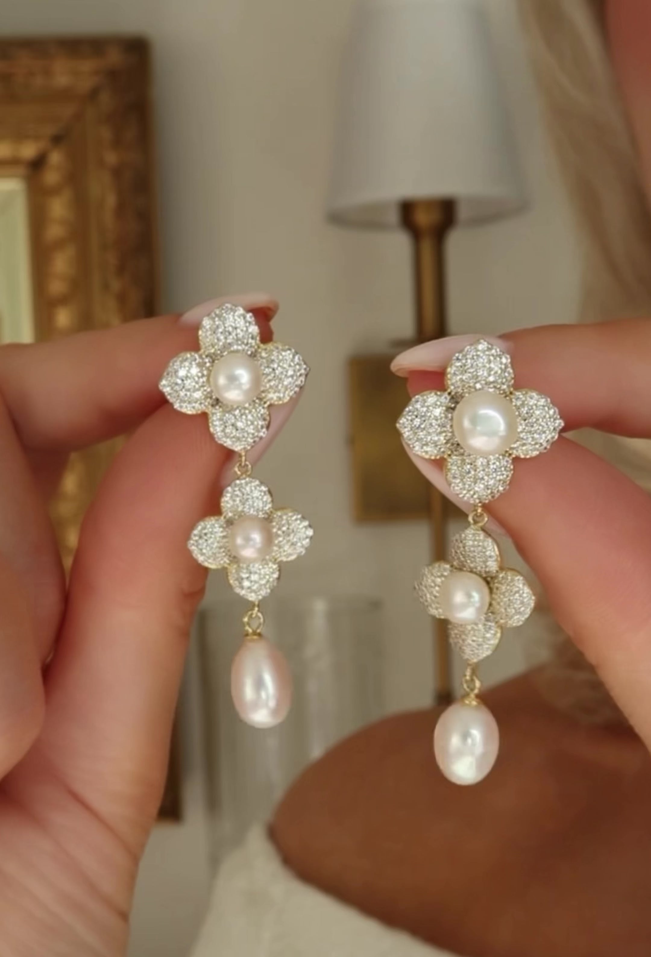 Gold Hydrangea Triple Pearl Earrings with freshwater pearls and CZ stones shown in motion to capture sparkle and movement