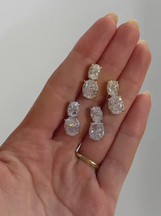 video of the white gold and gold plated Elodie earrings, in the palm of a hand, showcasing how they catch the light