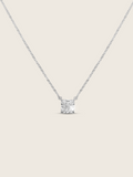 Regina necklace featuring a precisely cut square CZ stone set on a delicate sterling silver and white gold plated chain, displayed flat-lay on a white background to depict it's sparkle
