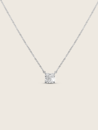Regina necklace featuring a precisely cut square CZ stone set on a delicate sterling silver and white gold plated chain, displayed flat-lay on a white background to depict it's sparkle