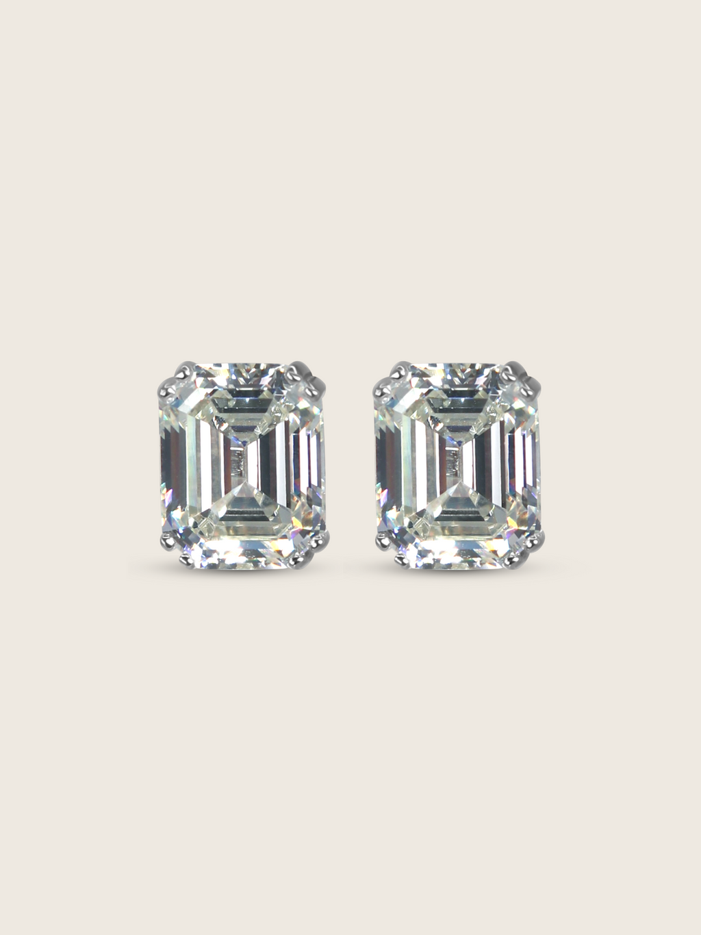 Seraphina stud earrings featuring emerald-cut cubic zirconia stones in white gold plated sterling silver, geometric design with brilliant faceting on neutral background