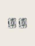 Seraphina stud earrings featuring emerald-cut cubic zirconia stones in white gold plated sterling silver, geometric design with brilliant faceting on neutral background