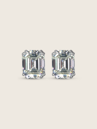 Seraphina stud earrings featuring emerald-cut cubic zirconia stones in white gold plated sterling silver, geometric design with brilliant faceting on neutral background