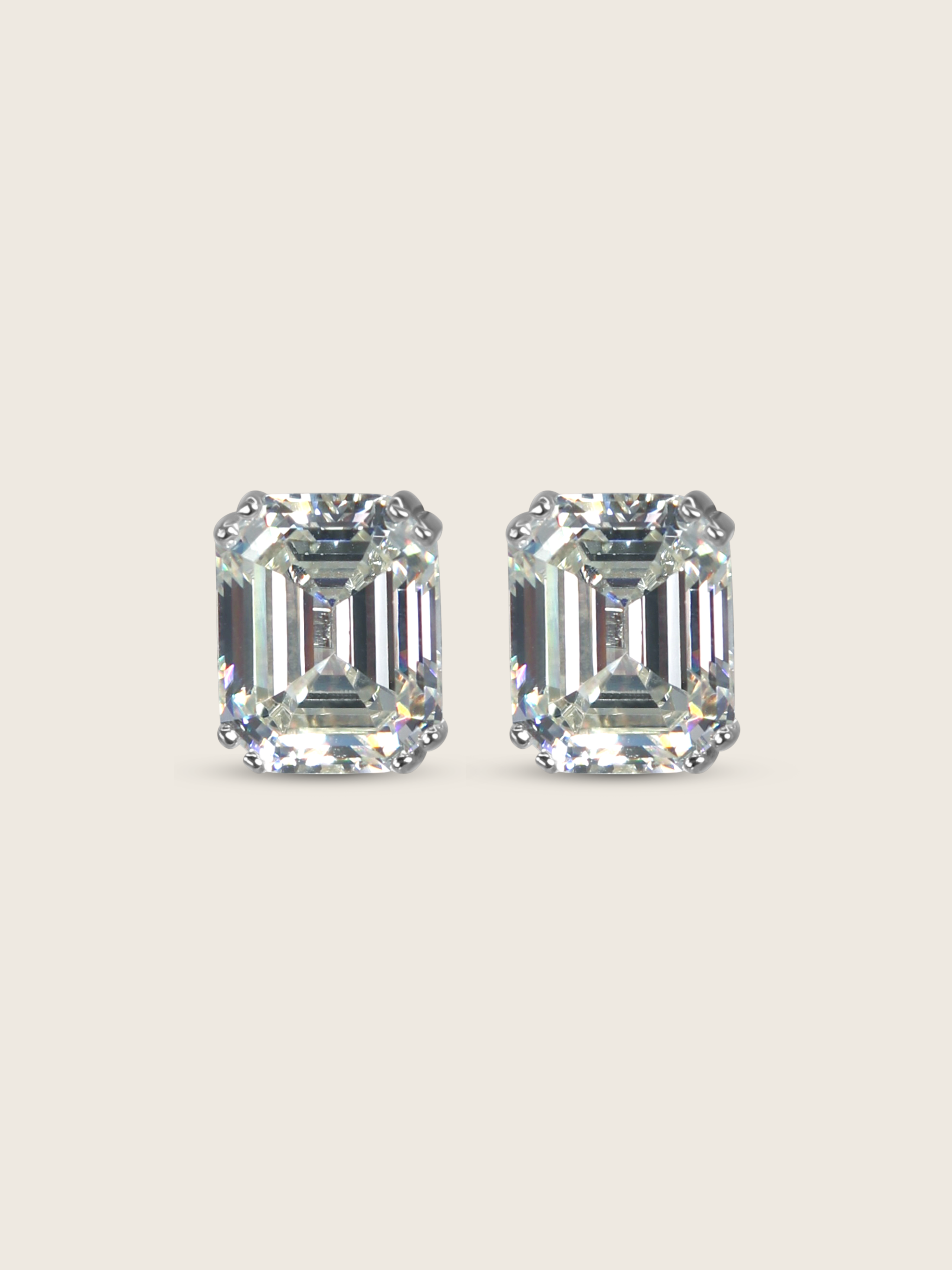 Seraphina stud earrings featuring emerald-cut cubic zirconia stones in white gold plated sterling silver, geometric design with brilliant faceting on neutral background