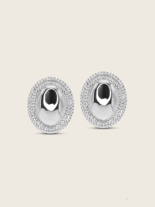 White Gold Plated Gigi Oval Stud earrings with sparkly CZ studs around the outside, shot on a neutral background