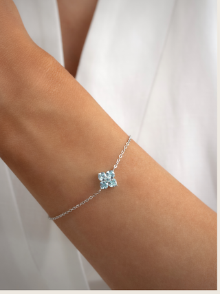 white gold plated crystal hydrangea bracelet worn on wrist close up showcasing the fine chain and the blue eye catching stones, dainty and perfect for weddings as something blue