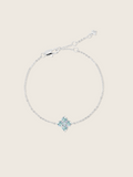 a flat lay of the white gold plated mini crystal hydrangea bracelet with aqua stones, sparkling on a neutral background 
