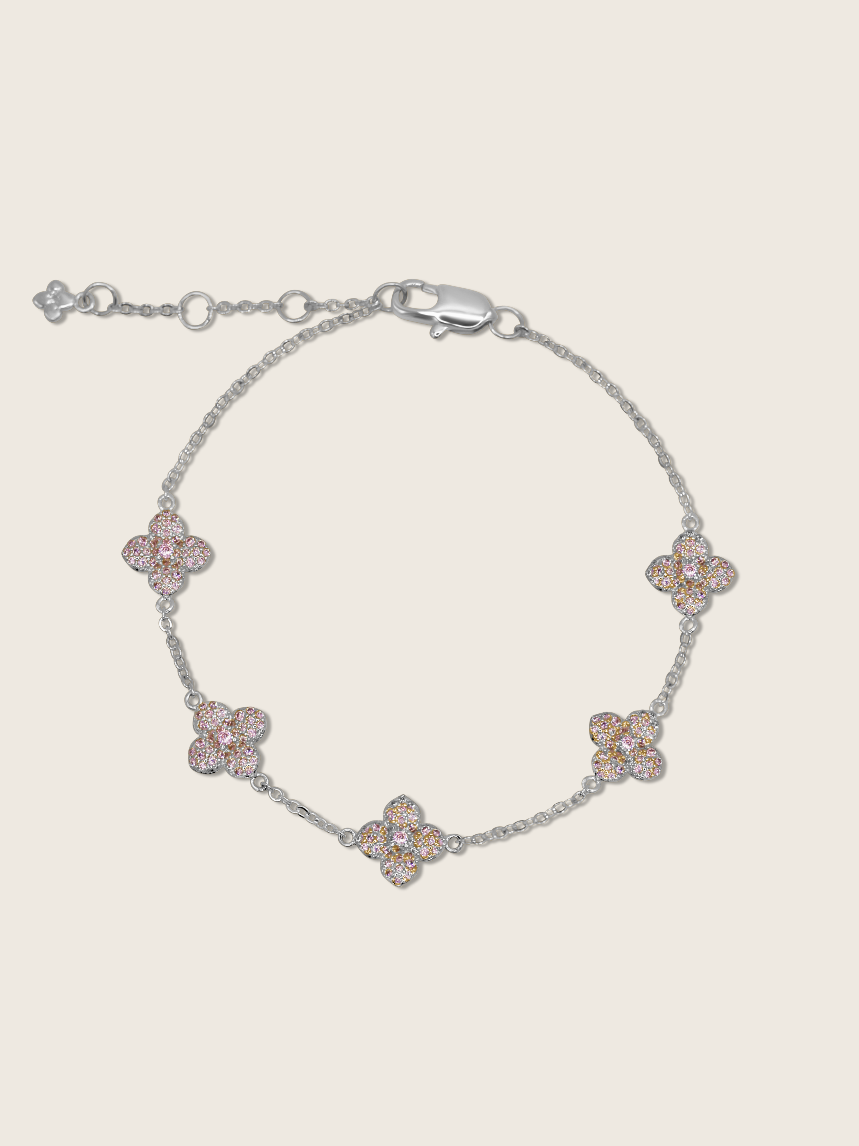 White gold plated bracelet with five light pink cubic zirconia hydrangea charms on fine chain, shown on neutral background